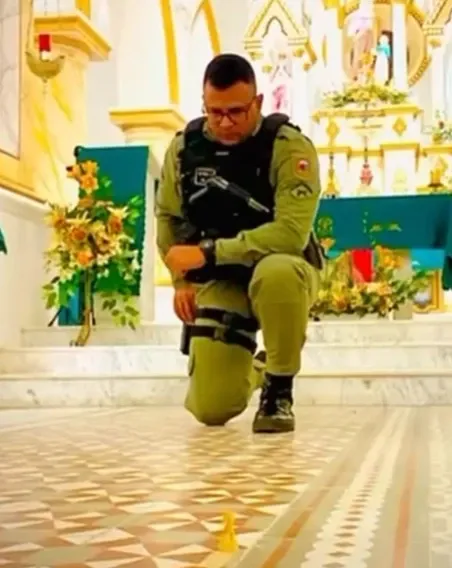 "Neto Pina Nascimento, policial militar do Rio Grande do Norte, ajoelhado diante do altar de uma igreja"